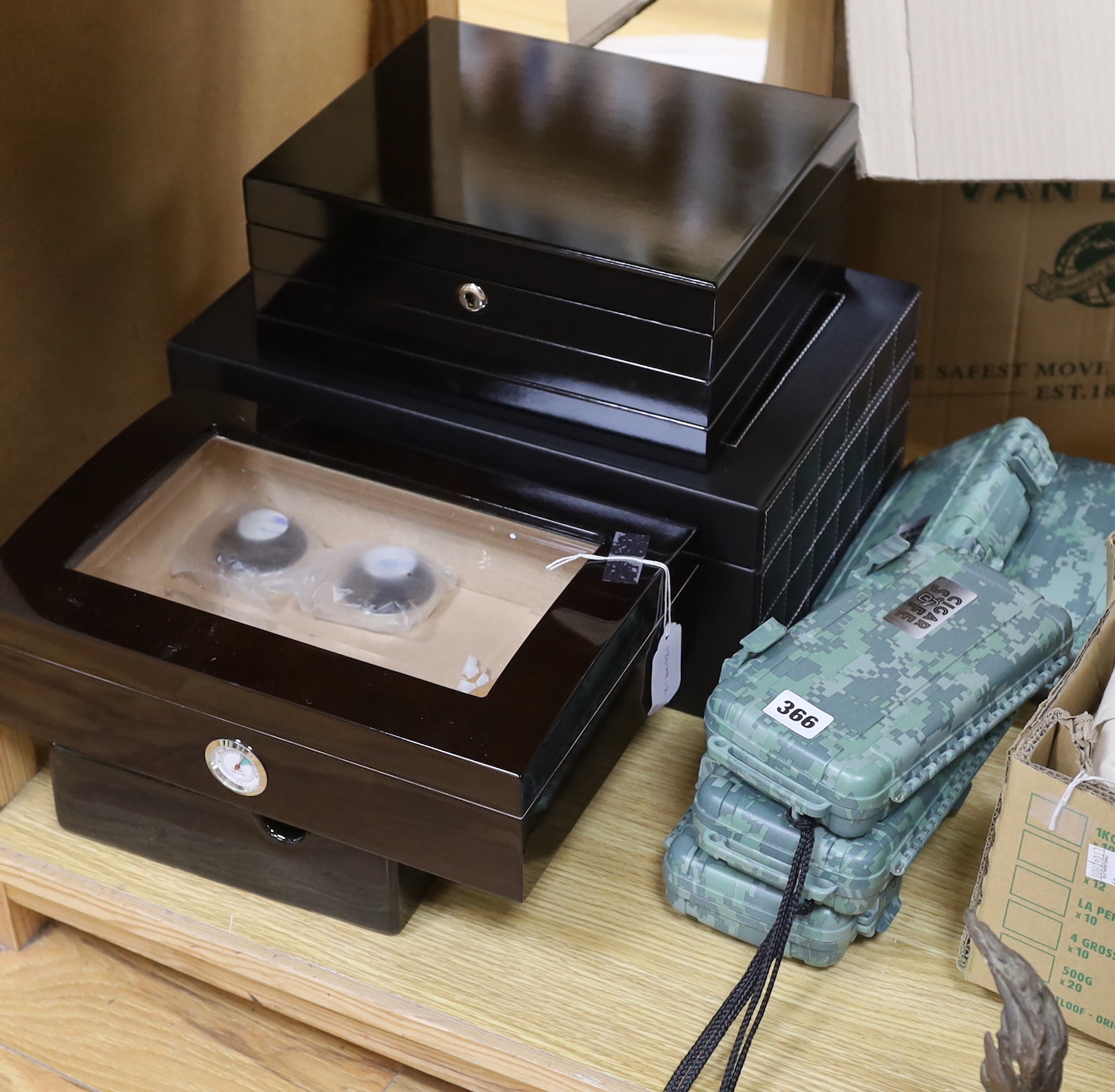 Three humidors, a large ashtray, and five cigar 'safes'